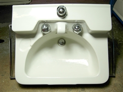 This is a genuine, original Crane Drexel Porcelain Wall Mounted Sink from the 1950's. This is a very unique wall hung sink with built-in porcelain spout, slant-back mount Dial-Ease faucet, built in soap recess and half-moon shaped bowl.