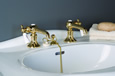 Strom Plumbing - P0058S Supercoat Brass Antique Reproduction Individual Basin Faucets with Side Mounted Porcelain Lever Handles. The P0058S porcelain lever handles indicate hot and cold.
