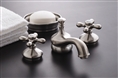 Strom Plumbing P0140C - Sacramento Chrome Plated Widespread Lavatory Faucet with Metal Cross Handles and Pop-Up Drain. The metal cross handles have a porcelain button for hot and cold.