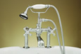Strom Plumbing - P0462C Polished Chrome 7 inch Center Deck Mount Tub Faucet with Metal Cross Handles. P0462 cross handles have porcelain buttons for hot and cold.